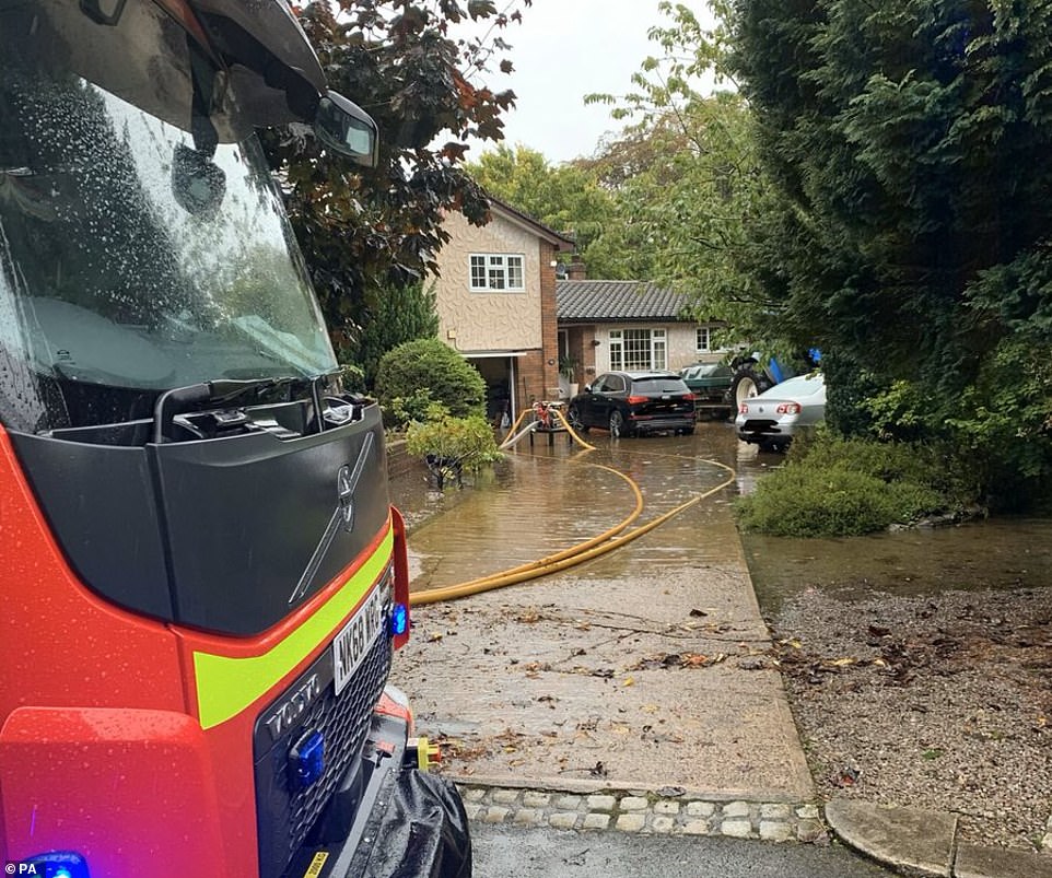 A fire engine outside a house which has suffered flooding this morning in Carlisle as Cumbria is hit by the bad weather