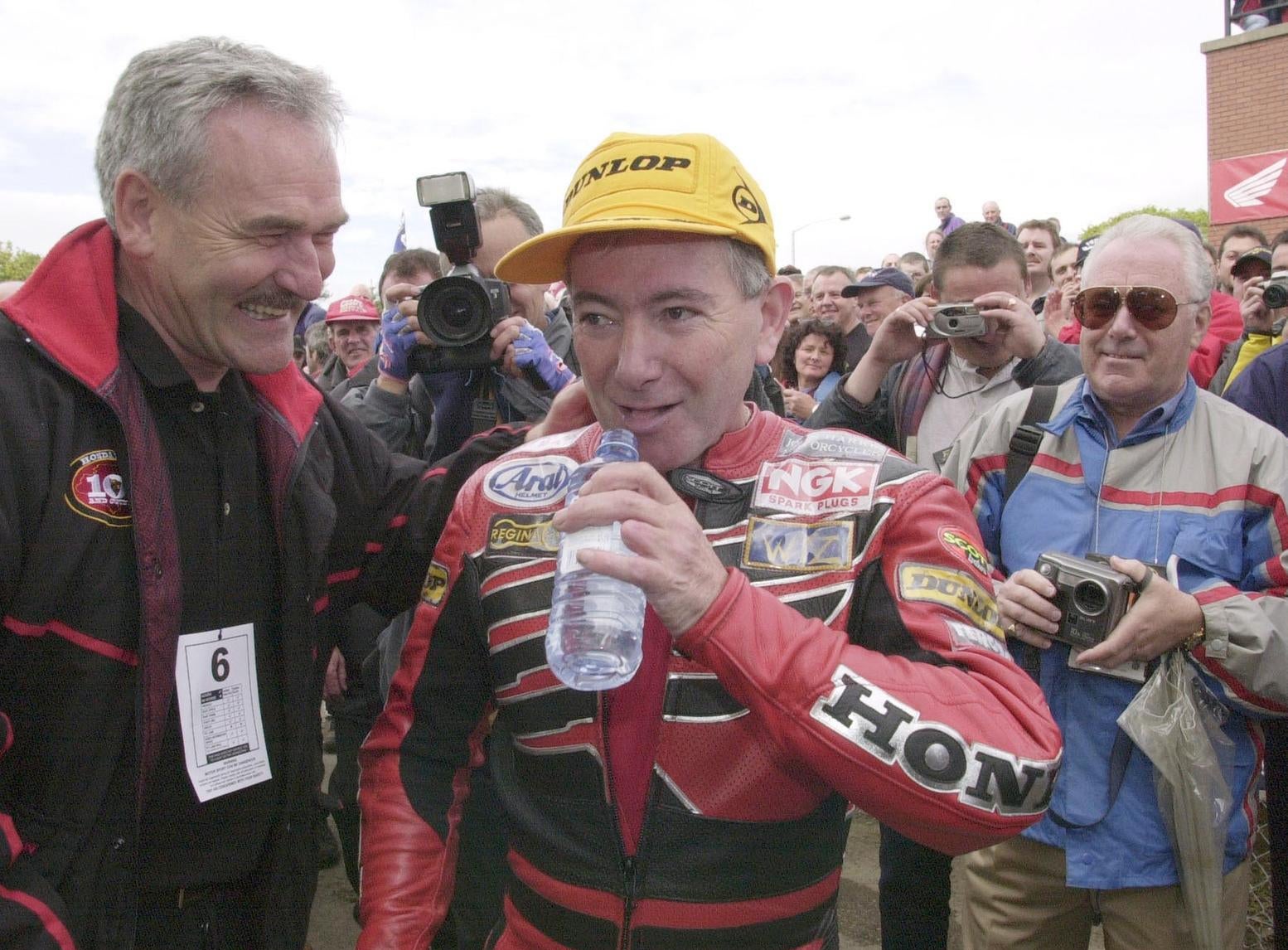 Joey Dunlop is congratulated on his victory in the Formula One race at the 2000 Isle of Man TT.