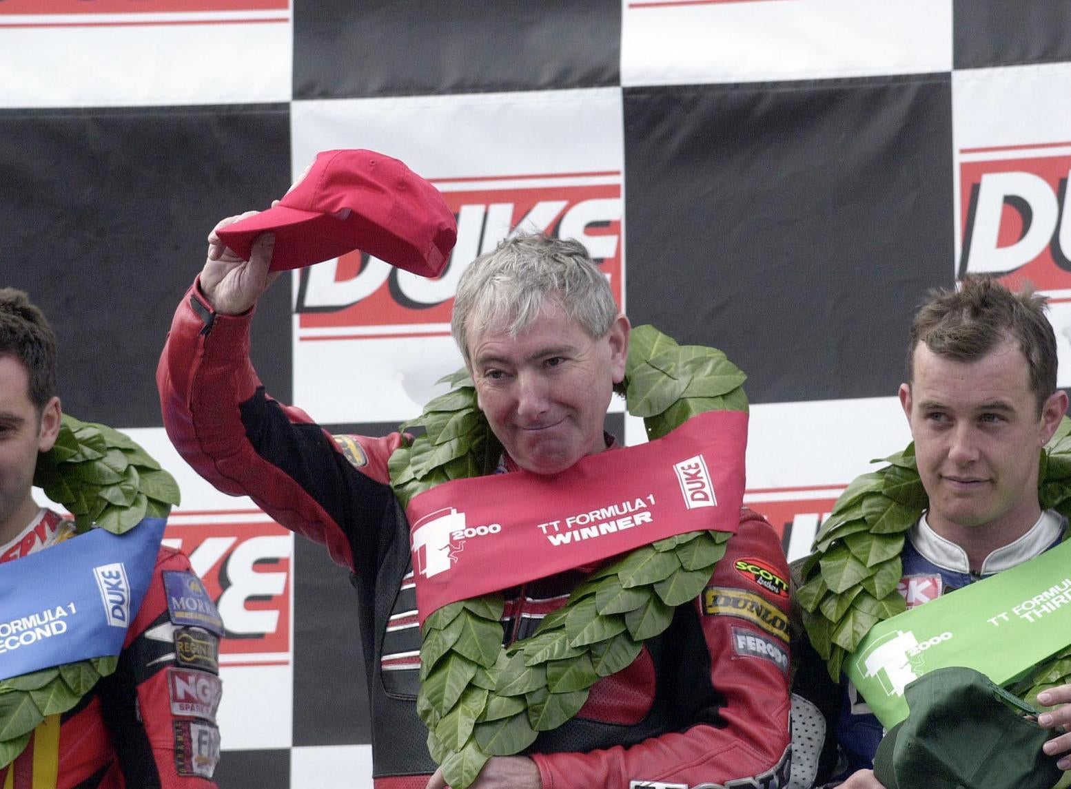 Formula One TT race winner Joey Dunlop on the rostrum with runner-up Michael Rutter (left) and John McGuinness.